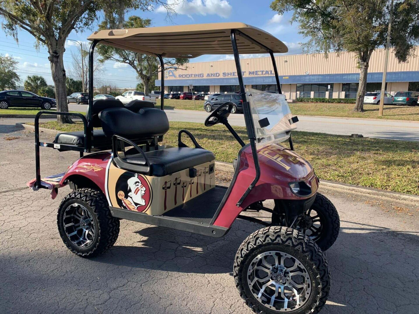 A picture of a golf cart with funky stickers