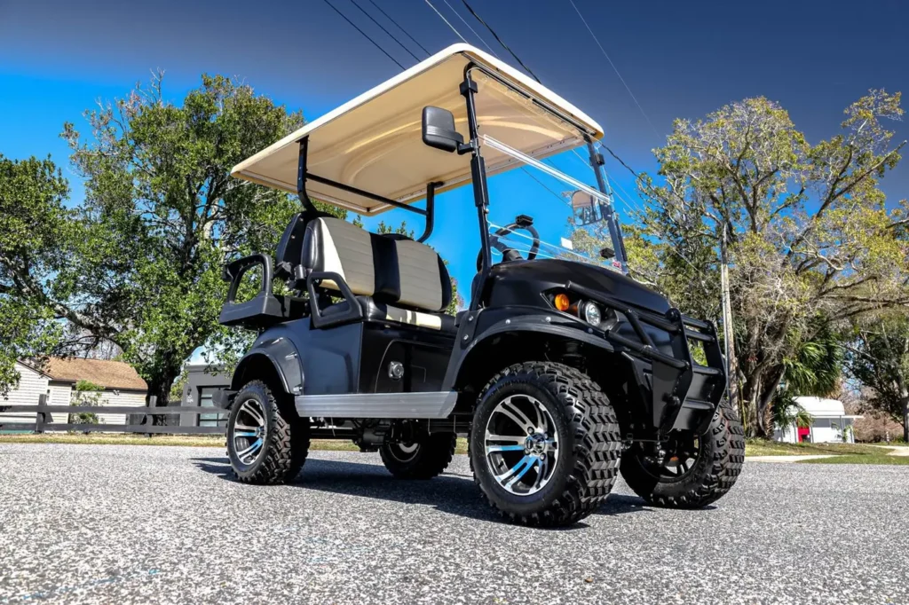 Black wrapped lifted golf cart with chrome wheels, front angle