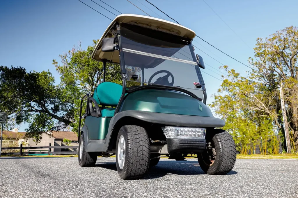 Green wrapped golf cart with LED light bar, front view, Orlando FL