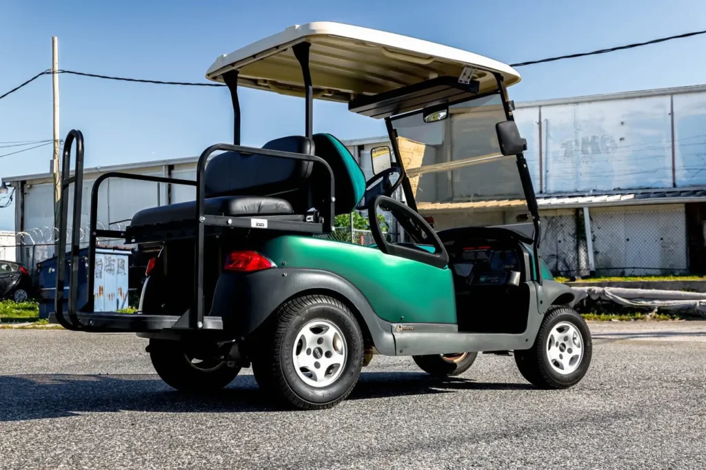 Green wrapped golf cart with rear flip seat, side view