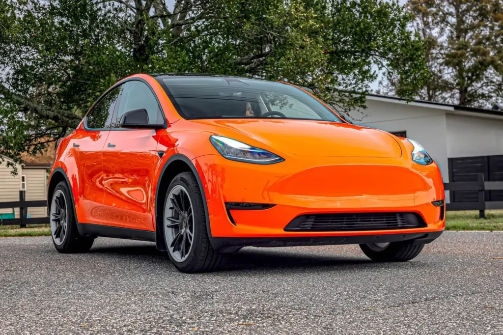 Tesla Model Y with an orange color change wrap